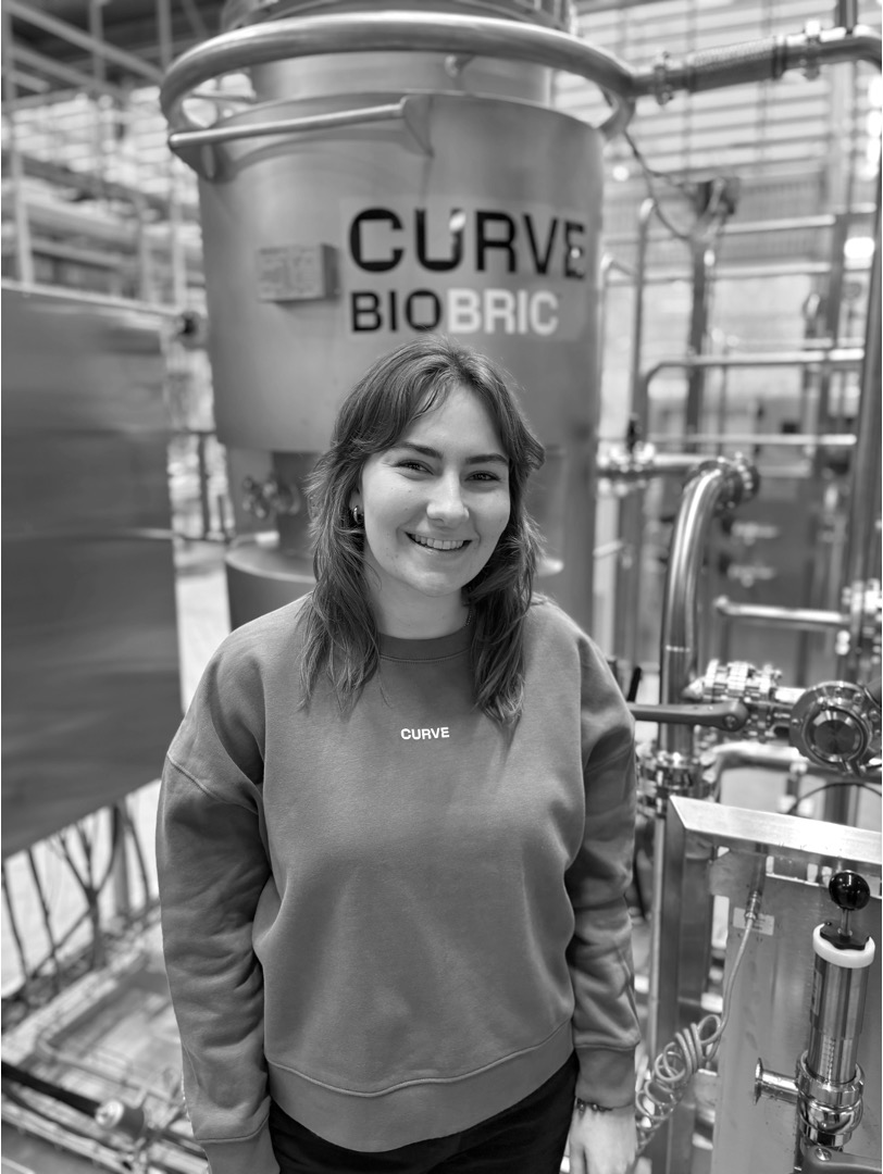 Elsa Axby standing beside Curve's bioreactor hardware.